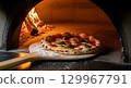 The moment the pizza is being baked 129967791