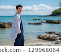 A medical intern standing on the beach of a remote island 129968064