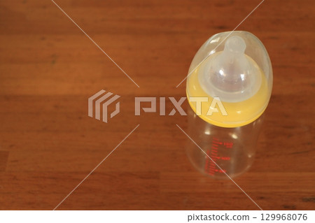 Baby bottle on the table 129968076