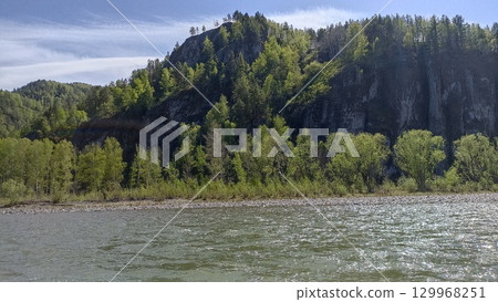 Picturesque Rocky Cliffside Landscape with Lush Green Trees and Calm River Scenery, Nature s Beauty 129968251