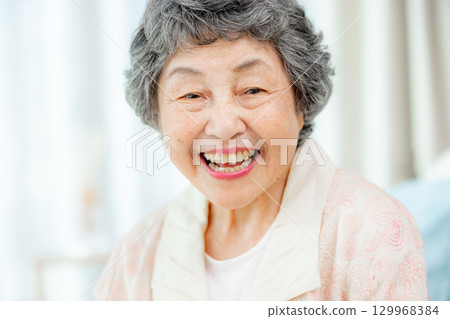 Senior woman feeling the moisture in her skin Senior woman feeling the moisture in her skin 129968384