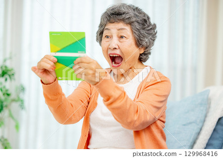 Senior woman holding a bankbook 129968416