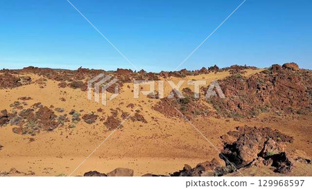 The stunning desert landscape features unique rocky terrain and beautiful clear skies 129968597