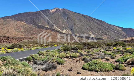 Breathtaking Road View of a Stunning Volcanic Mountainscape Under a Clear Blue Sky 129968641