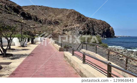 Enjoy a stunning scenic coastal walkway that runs beautifully along rocky shores for exploration 129968643