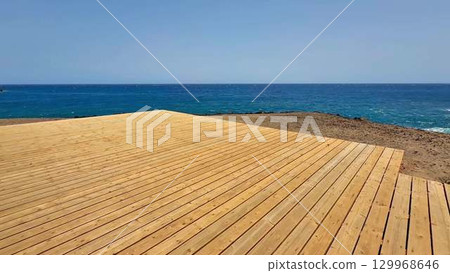 A Stunning Scenic Wooden Deck that Overlooks the Beautiful Expansive Ocean and Shoreline A Stunning Scenic Wooden Deck that Overlooks the Beautiful Expansive Ocean and Shoreline 129968646