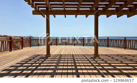 Enjoy the stunning oceanfront deck with breathtaking views, natural light, and captivating shadows 129968657