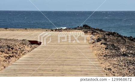 A Beautiful and Scenic Wooden Pathway That Gently Leads You to the Stunning Ocean Beyond A Beautiful and Scenic Wooden Pathway That Gently Leads You to the Stunning Ocean Beyond 129968672