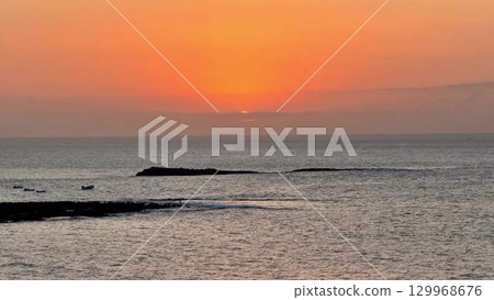 Experience a Stunning Sunset Over the Tranquil Ocean Waters on a Peaceful Evening 129968676