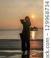 A person standing in the sunset at Lake Shinji 129968734