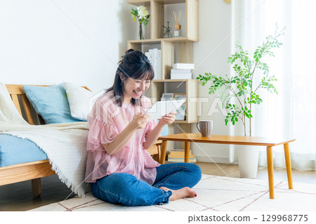 A young woman operating a tablet A young woman operating a tablet 129968775