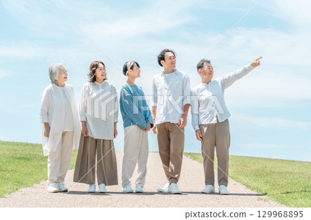 A happy family on a hill with a road, family, parents and children, three-generation family 129968895
