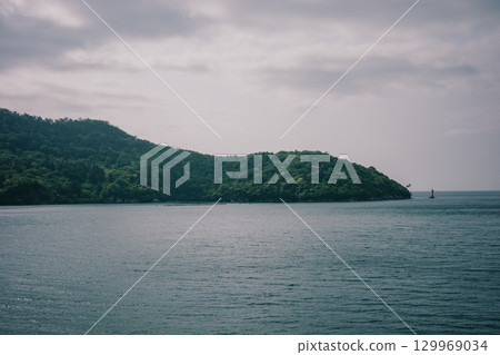 Calm sea under cloudy sky Calm sea under cloudy sky 129969034