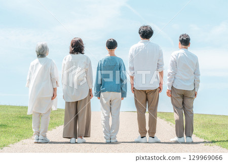 A happy family on a hill with a road, family, parents and children, three-generation family A happy family on a hill with a road, family, parents and children, three-generation family 129969066