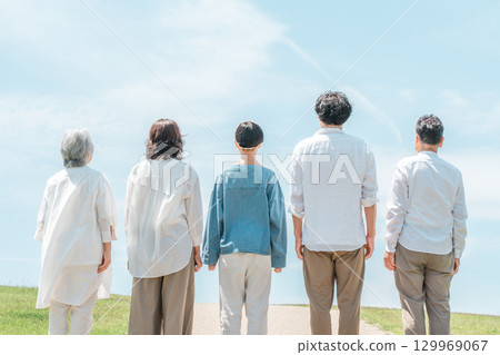A happy family on a hill with a road, family, parents and children, three-generation family A happy family on a hill with a road, family, parents and children, three-generation family 129969067