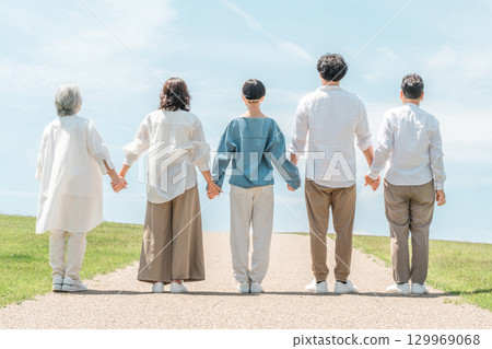 A happy family on a hill with a road, family, parents and children, three-generation family A happy family on a hill with a road, family, parents and children, three-generation family 129969068
