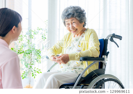 Young helper working at a nursing home 129969611