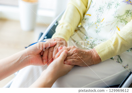 Young helper working at a nursing home Young helper working at a nursing home 129969612