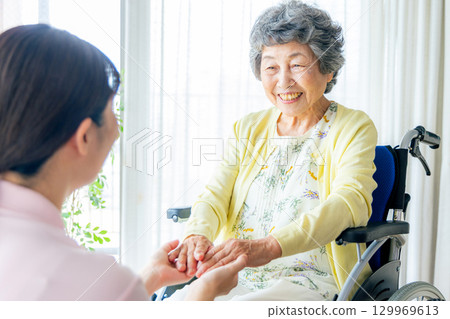 Young helper working at a nursing home 129969613
