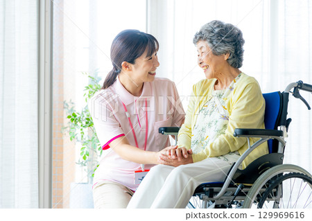 Young helper working at a nursing home Young helper working at a nursing home 129969616