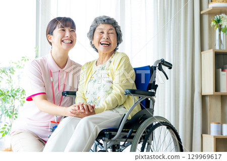 Young helper working at a nursing home Young helper working at a nursing home 129969617
