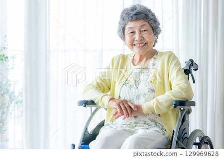 Senior women riding a wheelchair 129969628