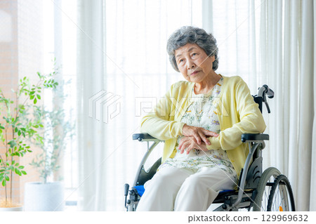 Senior woman in wheelchair worries 129969632