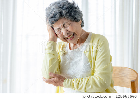 Senior woman suffering from headache 129969666