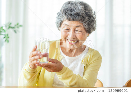 Senior woman drinking water Senior woman drinking water 129969691