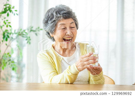 Senior woman drinking water 129969692