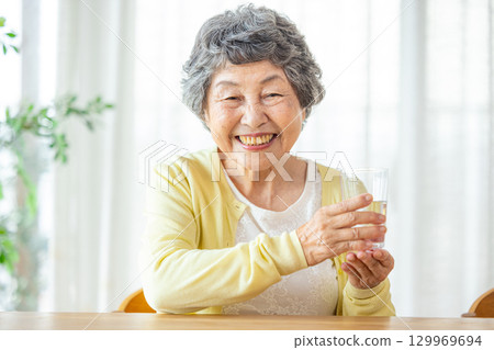 Senior woman drinking water Senior woman drinking water 129969694