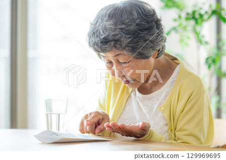 senior woman taking medicine senior woman taking medicine 129969695