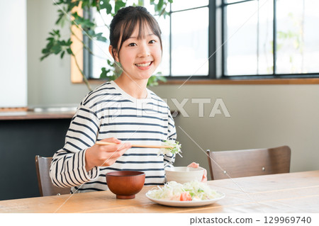 在餐桌上吃飯的小學和初中女生（午餐，早餐，米飯，吃飯） 129969740