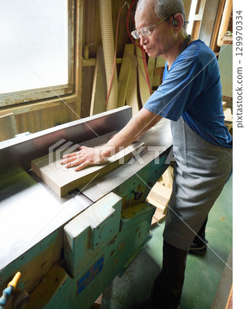 Skilled craftsmen working with wood 129970334