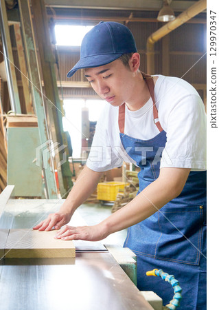 Young workers working on woodworking at a woodworking shop Young workers working on woodworking at a woodworking shop 129970347