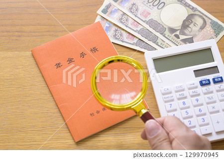 Pension book and calculator (plus magnifying glass) 129970945