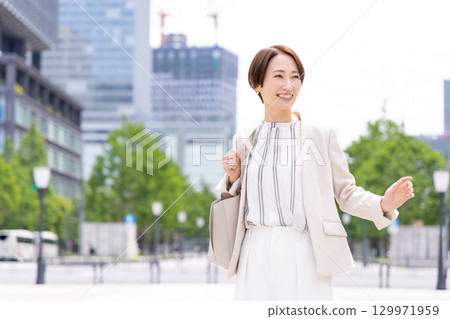A woman walking in a business office district A woman walking in a business office district 129971959