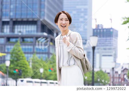 A woman walking in a business office district A woman walking in a business office district 129972022