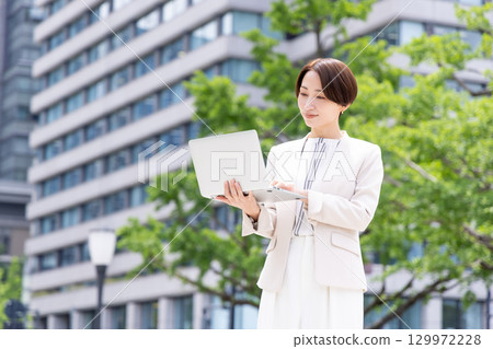 Business woman holding a tablet Business woman holding a tablet 129972228