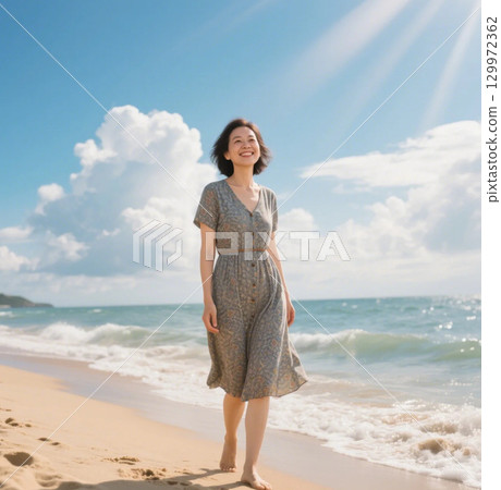 A woman walking along the beach 129972362