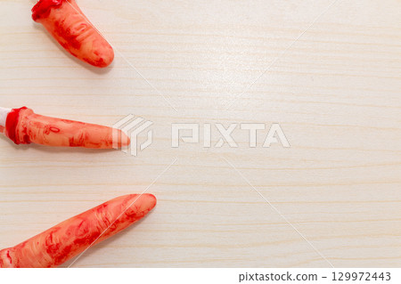 Horror-Themed Halloween Props on Wooden Surface 129972443