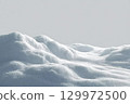 Beautiful snowdrift isolated on white background. Winter snow background. A big snow drift 129972500