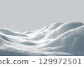Beautiful snowdrift isolated on white background. Winter snow background. A big snow drift 129972501