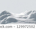 Beautiful snowdrift isolated on white background. Winter snow background. A big snow drift 129972502
