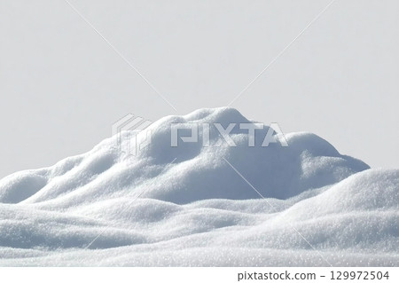 Beautiful snowdrift isolated on white background. Winter snow background. A big snow drift 129972504