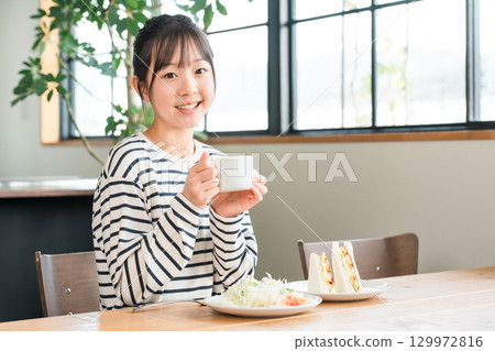 Girls drinking milk, hot milk, soup, juice, coffee for breakfast, lunch Girls drinking milk, hot milk, soup, juice, coffee for breakfast, lunch 129972816