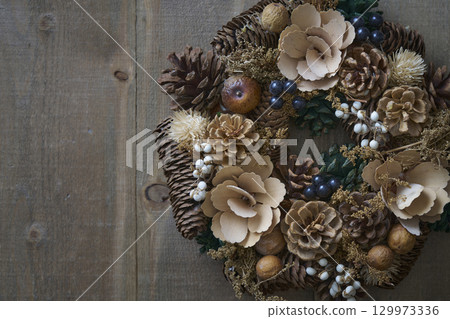 Christmas wreath on a wooden wall Christmas wreath on a wooden wall 129973336