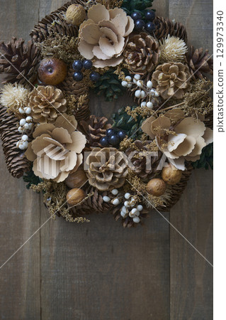 Christmas wreath on a wooden wall Christmas wreath on a wooden wall 129973340