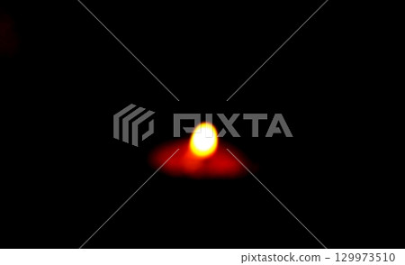 Blurred Burning Clay Oil Lamp in Darkness 129973510