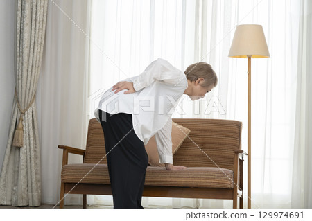 Senior woman with lower back pain Senior woman with lower back pain 129974691